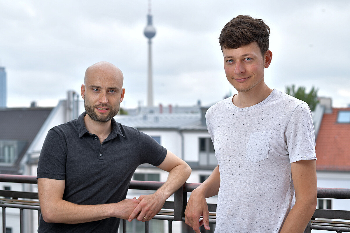 alcemy founders Dr. Robert Meyer and Leopold Spenner with the Alexanderplatz TV tower in the background.